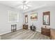A cozy bedroom with light gray walls and hardwood flooring, decorated with furniture and artwork at 7421 Meadow Violet Ct, Avon, IN 46123