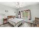 Cozy bedroom features ceiling fan, window with natural light, and hardwood floors at 7421 Meadow Violet Ct, Avon, IN 46123