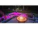 Backyard firepit with uplighting and beautiful landscape design at 7421 Meadow Violet Ct, Avon, IN 46123