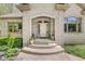 Inviting entrance with a beautiful arched doorway and manicured landscaping at 7421 Meadow Violet Ct, Avon, IN 46123