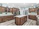Kitchen featuring stainless steel appliances, island with seating and light countertops at 7421 Meadow Violet Ct, Avon, IN 46123