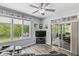Comfortable living room featuring neutral paint, ceiling fan, large windows, and access to the outdoor patio at 7421 Meadow Violet Ct, Avon, IN 46123
