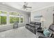 Comfortable living room featuring a reclining sofa, large windows with backyard views, and neutral carpet at 7421 Meadow Violet Ct, Avon, IN 46123