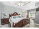 Spacious main bedroom featuring a beautiful accent wall, tray ceilings, wood floors, and luxury finishes at 7421 Meadow Violet Ct, Avon, IN 46123