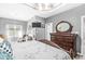Open main bedroom featuring a dresser, natural light, wood floors, ceiling fan, and neutral paint at 7421 Meadow Violet Ct, Avon, IN 46123