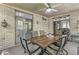 Charming sunroom featuring a rustic brick wall, dining table, and multiple windows providing views of the backyard at 7421 Meadow Violet Ct, Avon, IN 46123