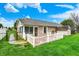A beautiful backyard with a well-maintained lawn, a white picket fence and mature landscaping at 7840 Park Ward Pl, Indianapolis, IN 46259