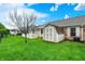 Spacious backyard featuring a storage shed, lush green grass, and a white picket fence at 7840 Park Ward Pl, Indianapolis, IN 46259