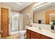 Well-lit bathroom featuring a shower with glass doors, vanity with a vessel sink, and modern fixtures at 7840 Park Ward Pl, Indianapolis, IN 46259