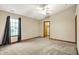 Bright bedroom with carpet, ceiling fan, and window at 7840 Park Ward Pl, Indianapolis, IN 46259