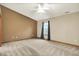 Bedroom featuring a ceiling fan, window, and accent wall at 7840 Park Ward Pl, Indianapolis, IN 46259