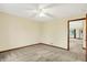 Neutral bedroom with carpet, ceiling fan, and view into hallway at 7840 Park Ward Pl, Indianapolis, IN 46259