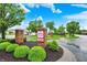 Community entrance sign for Bemiley Commons, a 55+ community, set among green landscaping under a blue sky at 7840 Park Ward Pl, Indianapolis, IN 46259