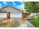 Charming brick home with a two-car garage, freshly landscaped flowerbed, and bright white trim accents at 7840 Park Ward Pl, Indianapolis, IN 46259