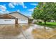 A well-maintained brick-and-vinyl home featuring an attached two-car garage, a tidy lawn, and mature trees at 7840 Park Ward Pl, Indianapolis, IN 46259