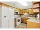 Functional kitchen with wooden cabinets, white appliances, and ample counter space at 7840 Park Ward Pl, Indianapolis, IN 46259