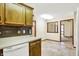 Kitchen with wood cabinets and view into the dining room at 7840 Park Ward Pl, Indianapolis, IN 46259