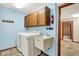 Laundry room with utility sink, washer, dryer, and overhead cabinet at 7840 Park Ward Pl, Indianapolis, IN 46259