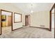 Open living area with neutral carpet, ample doorways, and chandelier lighting creates a welcoming atmosphere at 7840 Park Ward Pl, Indianapolis, IN 46259