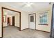 Comfortable living room featuring neutral walls, a ceiling fan, and doorway leading to other spaces at 7840 Park Ward Pl, Indianapolis, IN 46259
