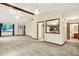 Spacious living area featuring high ceilings, a ceiling fan, an open floor plan, and neutral carpeting throughout at 7840 Park Ward Pl, Indianapolis, IN 46259