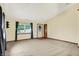 An empty carpeted living room with a large window and neutral-toned walls for versatile decorating options at 7840 Park Ward Pl, Indianapolis, IN 46259