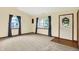 Bright and airy living room featuring large windows with curtains, neutral carpeting, and ample natural light at 7840 Park Ward Pl, Indianapolis, IN 46259