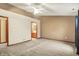 Large main bedroom with neutral carpeting, ceiling fan, en-suite bathroom, and a bright, airy atmosphere at 7840 Park Ward Pl, Indianapolis, IN 46259