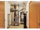 Utility room featuring a furnace, water heater, and water softener for the home's essential systems at 7840 Park Ward Pl, Indianapolis, IN 46259