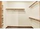 Empty walk-in closet with wood trim with ample shelving and hanging space at 7840 Park Ward Pl, Indianapolis, IN 46259