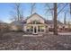 Home's backyard with a patio area, and enclosed sunroom at 7910 Teel Way, Indianapolis, IN 46256