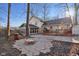 The home's backyard includes a stone firepit and a wood deck with an umbrella at 7910 Teel Way, Indianapolis, IN 46256