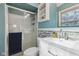 Updated bathroom with glass shower, vanity sink, and natural stone accent wall at 7910 Teel Way, Indianapolis, IN 46256