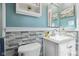 Charming bathroom featuring a stone accent wall, vanity sink, and built-in shelf at 7910 Teel Way, Indianapolis, IN 46256