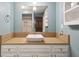 Stylish bathroom featuring a vessel sink, wood counter, white cabinets, and updated fixtures at 7910 Teel Way, Indianapolis, IN 46256
