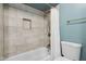 Bathroom featuring a tiled shower-tub combination with updated gold-tone fixtures and a niche at 7910 Teel Way, Indianapolis, IN 46256