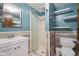 Well-lit bathroom with a glass shower, modern vanity, and wood-look wainscoting at 7910 Teel Way, Indianapolis, IN 46256