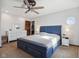 Bright bedroom with a blue platform bed, dresser, and unique window, offering comfort and style at 7910 Teel Way, Indianapolis, IN 46256