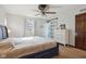 Bedroom featuring a bed with a sliding door, window, and dresser, offering comfort and convenience at 7910 Teel Way, Indianapolis, IN 46256