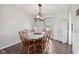 Bright dining room featuring wood floors and a wooden table with 6 chairs at 7910 Teel Way, Indianapolis, IN 46256