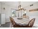 Inviting dining room featuring an elegant light fixture above a wooden dining table at 7910 Teel Way, Indianapolis, IN 46256