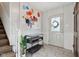 Bright entryway featuring a white front door, stylish flooring, modern art, and staircase at 7910 Teel Way, Indianapolis, IN 46256