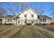 Beautiful exterior view of home featuring stone details, well-maintained lawn, and mature trees at 7910 Teel Way, Indianapolis, IN 46256