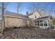 Home exterior features a stone facade, patio area, and enclosed sunroom at 7910 Teel Way, Indianapolis, IN 46256