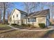 Exterior shot showing side yard, stone accents, mature trees, and sidewalk at 7910 Teel Way, Indianapolis, IN 46256