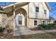 Close up of home entrance highlighting stone accents, front door with wreath, and covered porch at 7910 Teel Way, Indianapolis, IN 46256