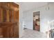 Hallway with wood door leading to modern kitchen with stainless steel appliances at 7910 Teel Way, Indianapolis, IN 46256