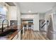 Spacious kitchen featuring butcher block countertops, breakfast bar, stainless steel appliances, and white cabinetry at 7910 Teel Way, Indianapolis, IN 46256