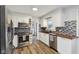 Modern kitchen with stainless steel appliances, white cabinetry, butcher block countertops, and stylish tile backsplash at 7910 Teel Way, Indianapolis, IN 46256