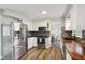 Modern kitchen with stainless steel appliances, white cabinetry, and butcher block countertops at 7910 Teel Way, Indianapolis, IN 46256